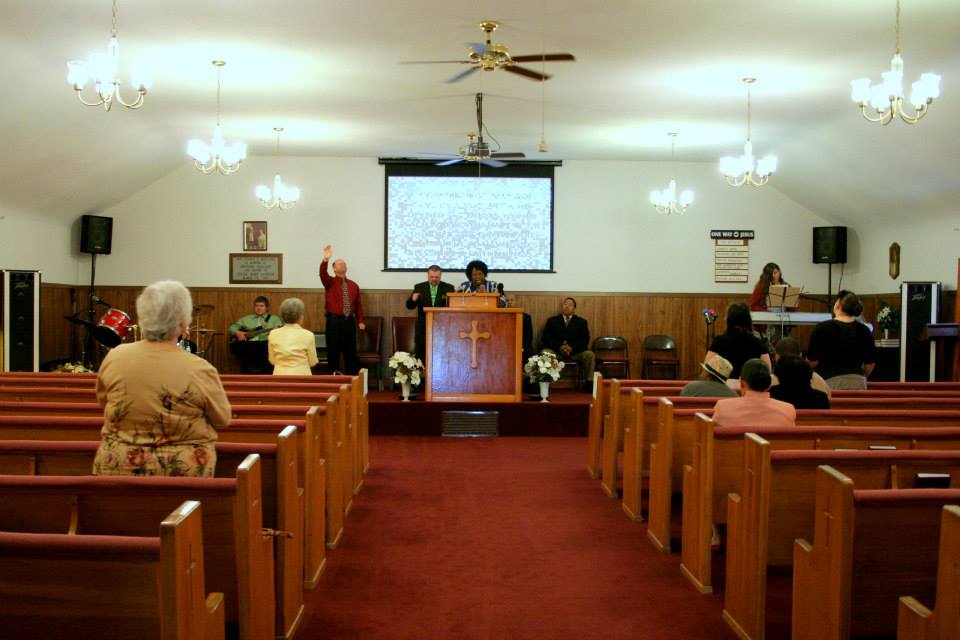Traditional church service interior with congregation worshipping